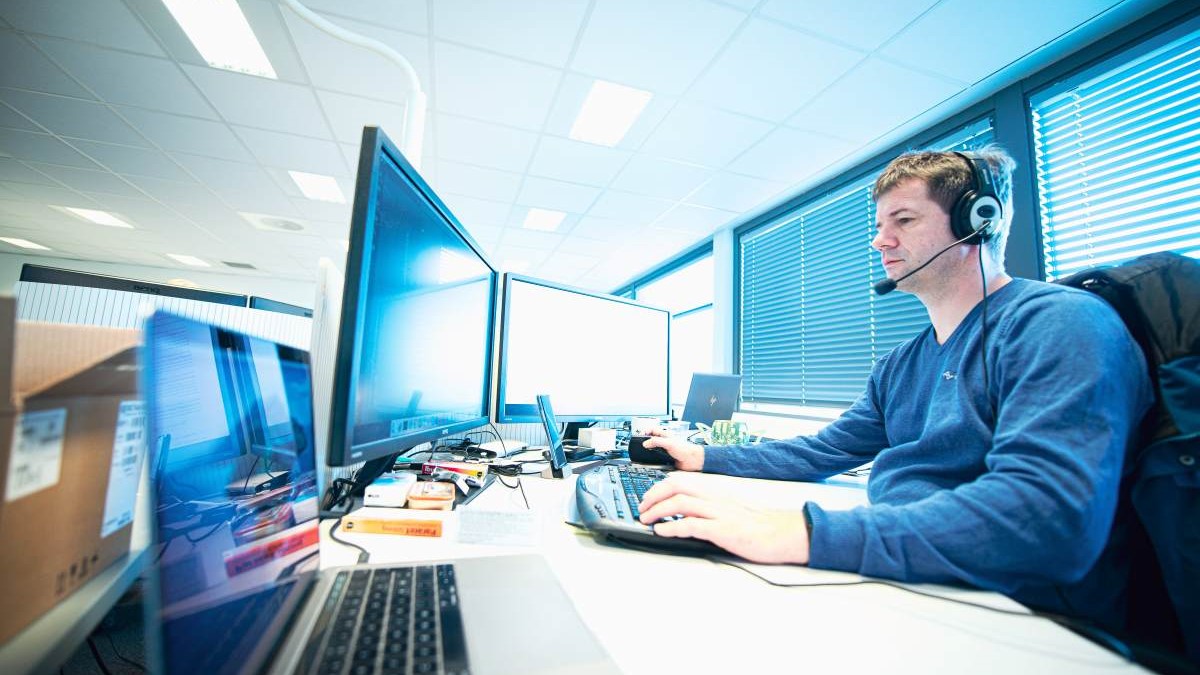 Picture of Test Engineer in front of labtop and pc monitor