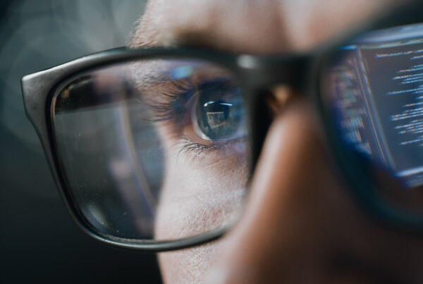 Close-up Portrait of Test Engineer Working on Computer, Line of Code Reflecting in Glasses